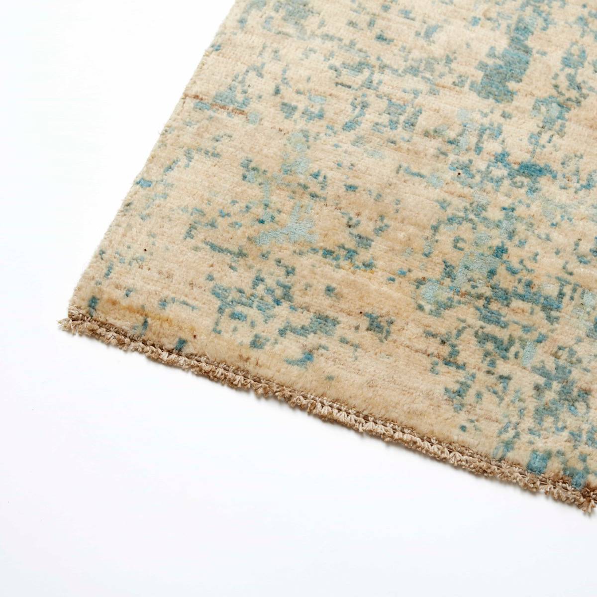 Aura matta från Nobilis i blågrön/beige — detalj